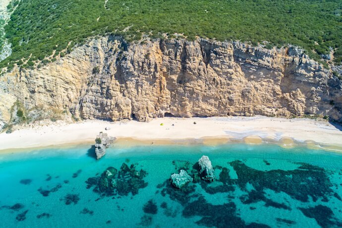 Crystal blue waters of a beach in Arrábida Nature Park