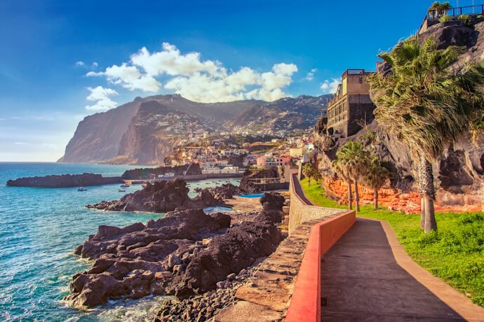 Funchal Lido promenade with ocean and cliffs.