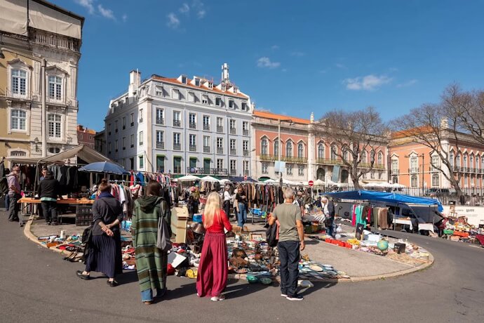 People on a sunny day exploring Lisbons Feira da Ladra