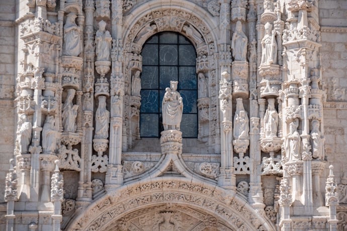 Intricate Manueline stone carvings and religious sculptures on the facade of the Church of Santa Maria de Belém.