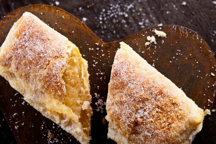 Close-up of a Portuguese travesseiro pastry, flaky and sugar-dusted, traditional from Sintra, Portugal