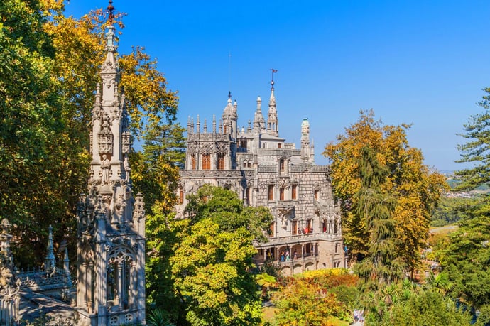 Quinta da Regaleira in Sintra, Portugal, surrounded by lush gardens and ornate Gothic-style architecture