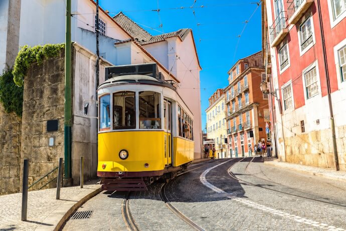Yellow funicular on a steep street in Lisbon, Portugal