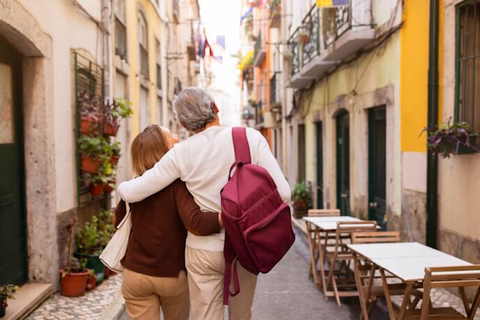 Couple walking through a narrow street in Lisbon’s historic Bairro Alto district