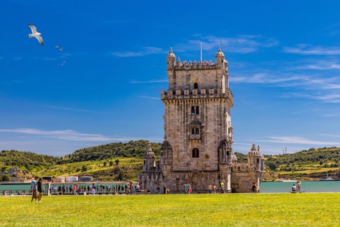 Belém Tower in Lisbon, Portugal, beside the Tagus River under a clear blue sky