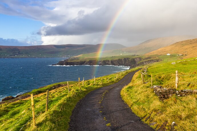 Rainbow over coastal road along Ireland’s rugged Atlantic coastline.