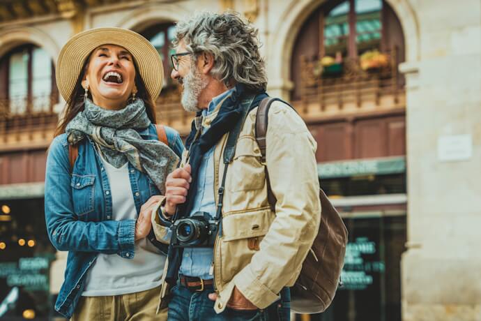 Happy couple sightseeing in an Irish city street while traveling together.