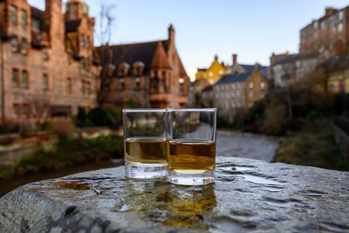 Two glasses of Scotch whisky overlooking Dean Village.