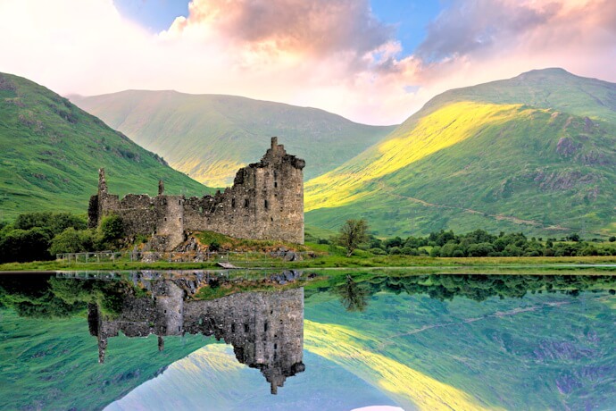 Kilchurn Castle reflected in the calm waters of Loch Awe.