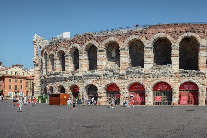 People passing by the Roman amphitheater in Verona, Italy