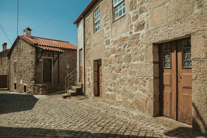 Cobbled street in Belmonte with stone houses.