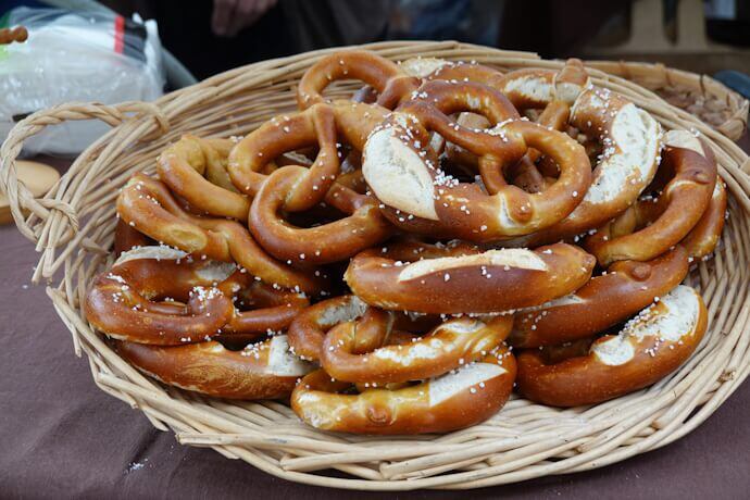 Golden-brown pretzels with a glossy crust and coarse salt, freshly baked and arranged in a tempting stack. A typical snack in Strasbourg.