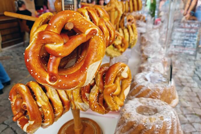 Traditional salted pretzels displayed at an outdoor market stall in Strasbourg