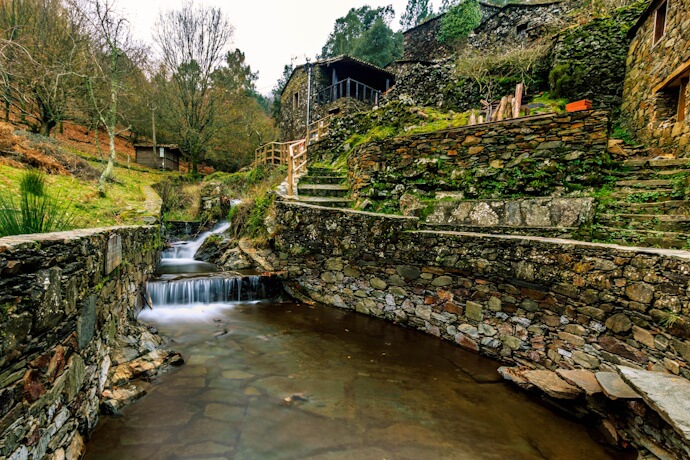 A quiet stream runs through the stone houses of the Lousã villages, near Coimbra.