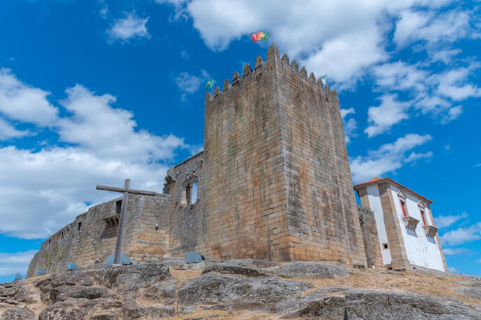 Historic hilltop castle with stone tower and chapel overlooking Belmonte.