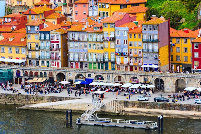 Colorful riverside houses and lively waterfront in Porto’s Ribeira district.