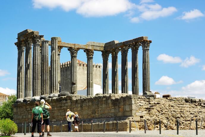 Tourists visiting the Roman Temple of Évora in Portugal.