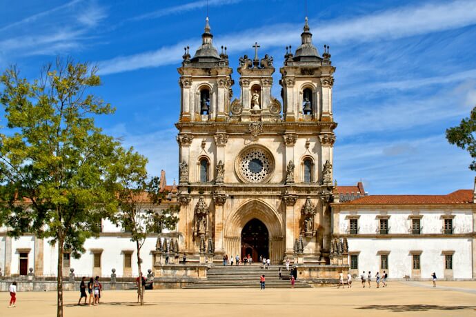 People visiting Alcobaça Monastery in Portugal.
