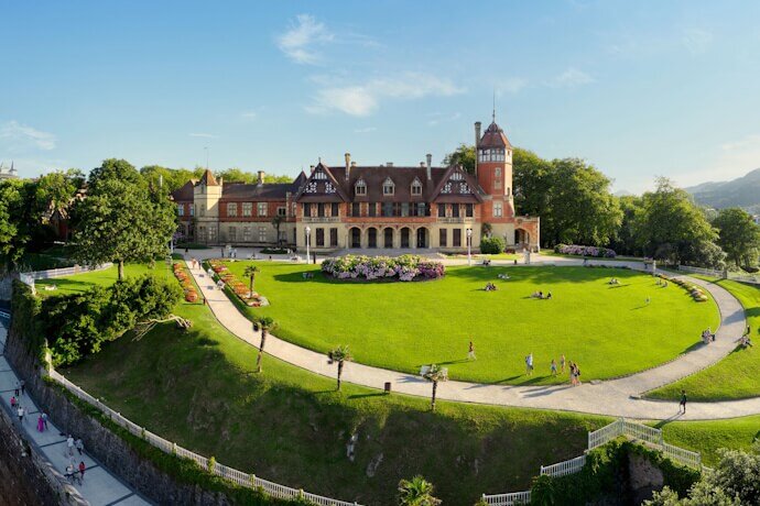 People on a sunny day exploring the Palacio Miramar Gardens in San Sebastian