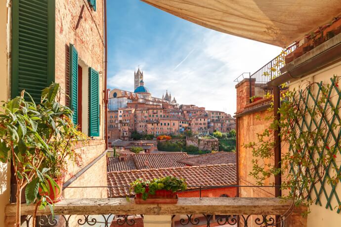Panoramic view of Siena, Italy, seen from a rustic balcony, autumn travel atmosphere in Europe