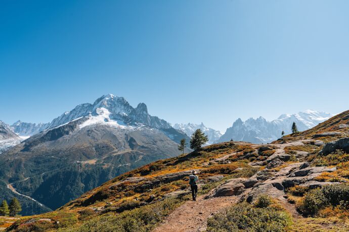 Snowy alpine landscape in France with hiking trail and dramatic mountain peaks, winter travel in Europe