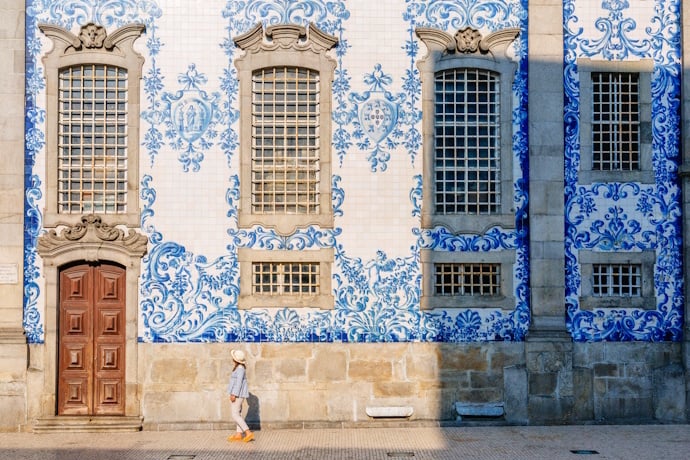 Traditional blue-and-white azulejo tiles decorating a historic building in Porto, Portugal.