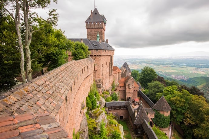 Château du Haut-Koenigsbourg, with its fortress walls and towers perched high above the forests and vineyards, overlooking the vast plain.