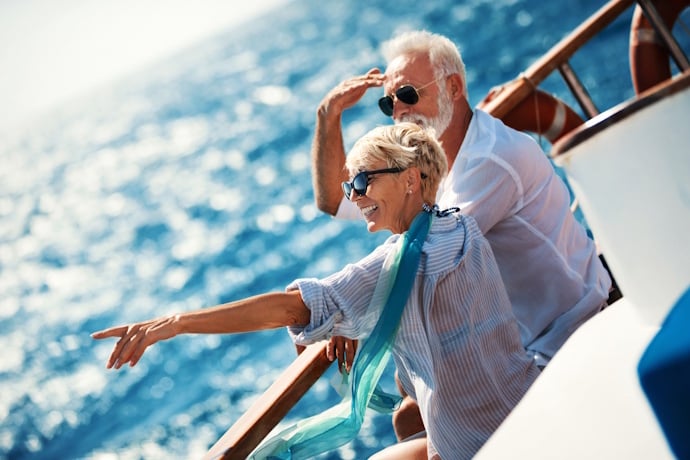 Couple relaxing on deck while taking in Madeira Island ocean views.