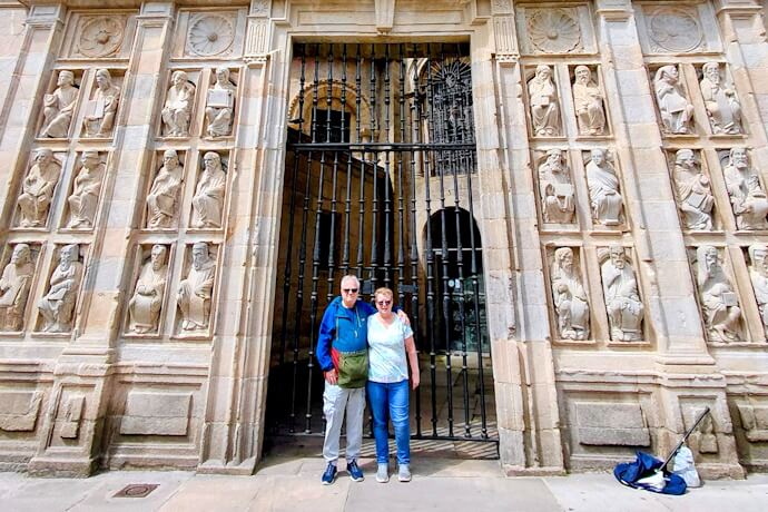Couple standing beside the Cathedral of Santiago de Compostela entrance