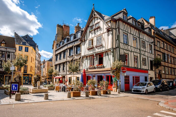 Colorful half-timbered houses and a charming café terrace in the historic center of Rouen, Normandy