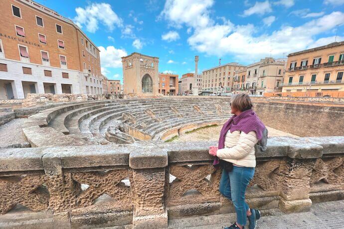 Woman appreciating the ancient Roman anfiteatro in Lecce