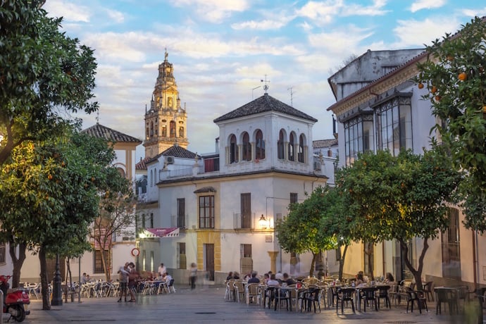 Jewish quarter street in Córdoba, Spain, with the bell tower of The Mosque-Cathedral