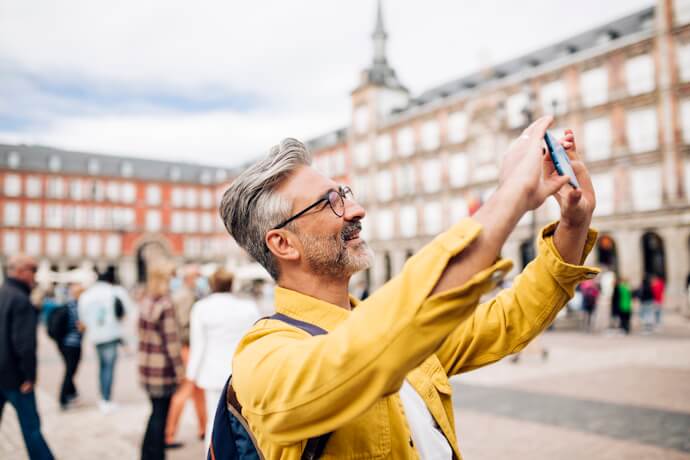 Tourist taking a picture in Plaza Mayor, in Madrid, Spain