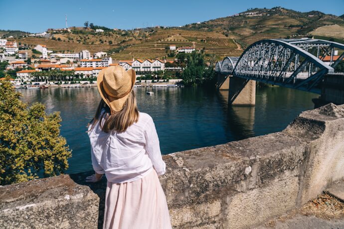 Woman overlooking the Douro River and bridge in Peso da Régua