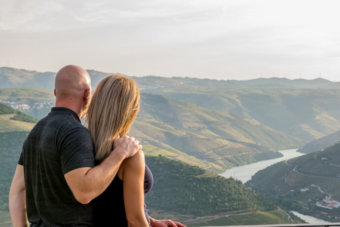 Couple admiring panoramic views over the Douro Valley and river