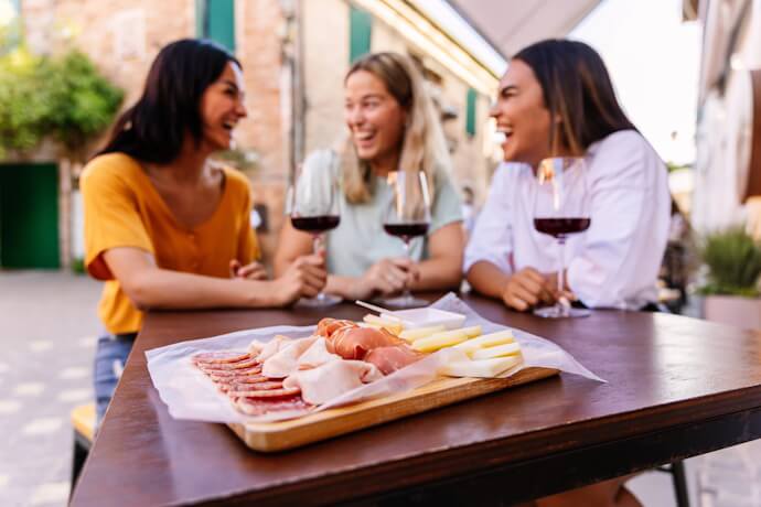 Friends enjoying wine and tapas in Spain