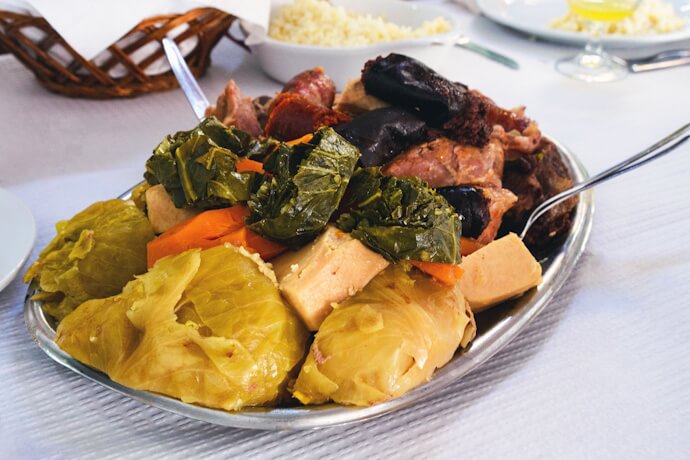 Traditional Cozido das Furnas stew served in São Miguel, Azores, with meat, sausages, cabbage, and vegetables.