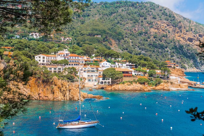 Costa Brava cove with sailboat