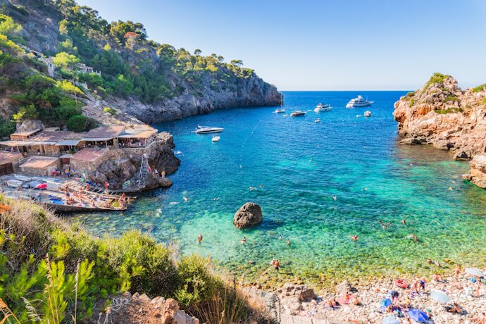 Turquoise beach cove in Mallorca, Spain, with clear water and Mediterranean coastline