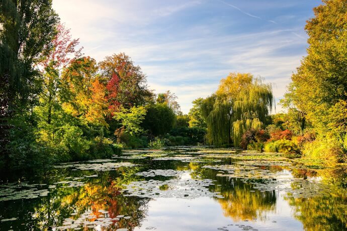 Garden landscape in Monet's House in France, with autumn colors and reflective water scenery