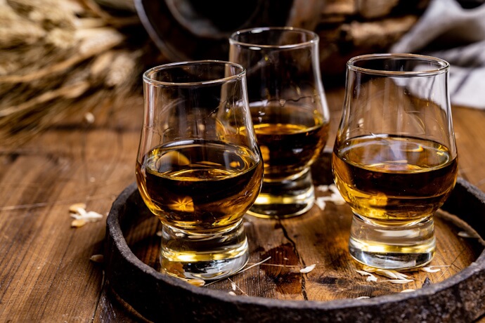 A trio of golden Scotch whiskies.