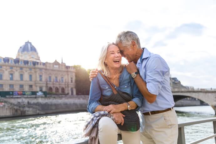 Senior couple enjoying a romantic moment along the Seine in Paris.