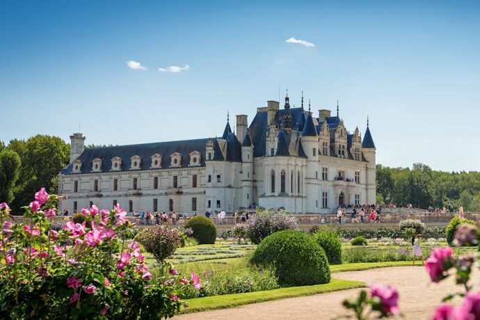 Scenic view of Château de Chenonceau and the formal gardens with pink flowers