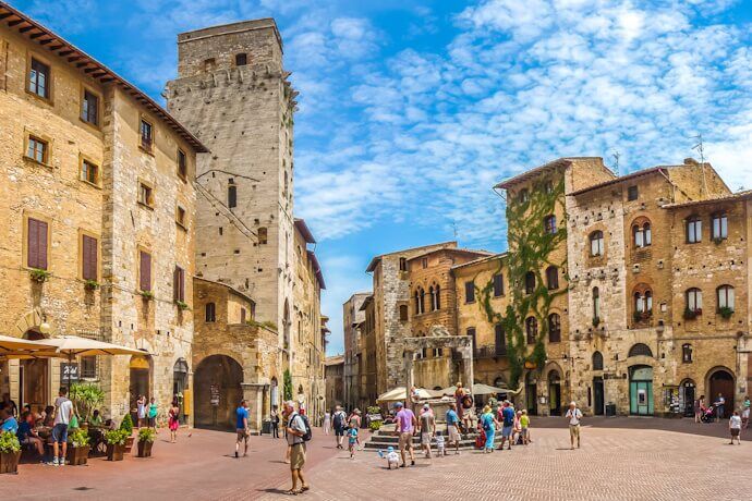Medieval stone buildings in Piazza della Cisterna in San Gimignano, Italy