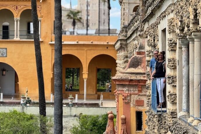 Couple exploring historic Spanish alcazar and its moorish architecture