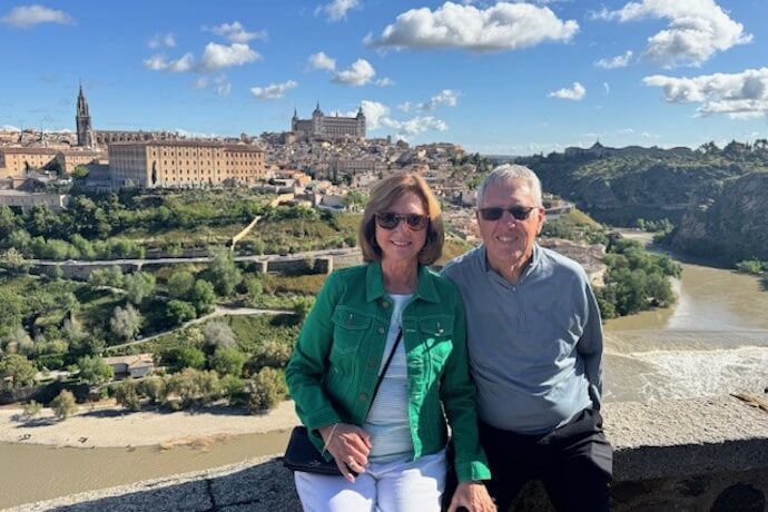 Senior couple posing for a photo on a sunny day in Toledo, Spain