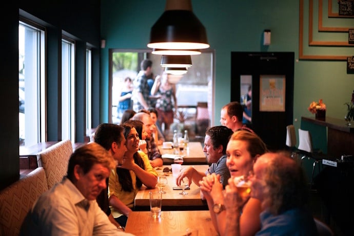 People dining together at a lively restaurant in Portugal.