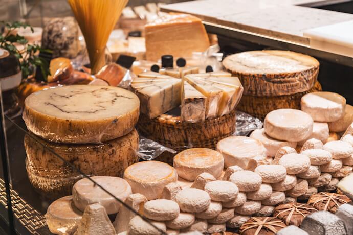 Traditional French cheeses displayed at a market in Lyon