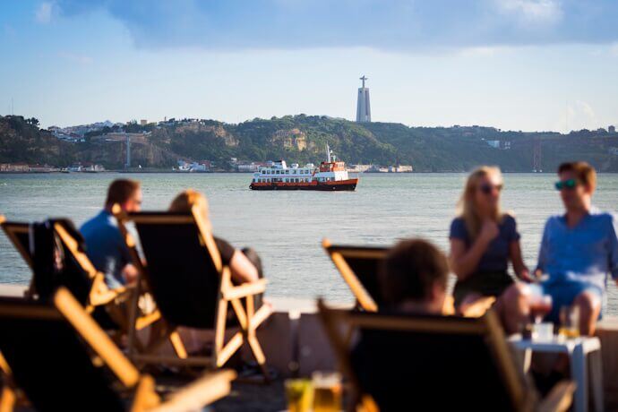Tagus River in Lisbon with ferry and Christ the King statue