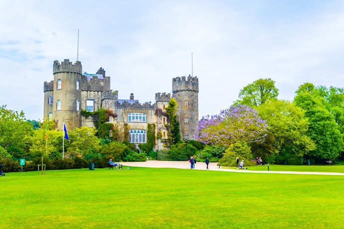 Medieval Malahide Castle surrounded by green lawns and gardens in County Dublin, Ireland.